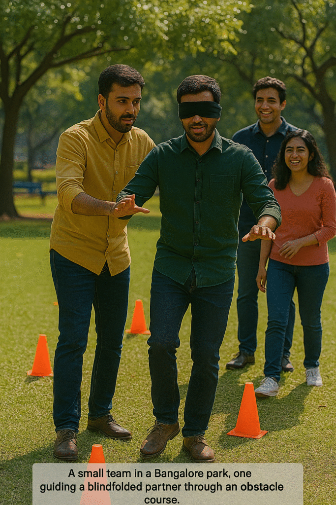 A small team in a Bangalore park, one guiding a blindfolded partner through an obstacle course.